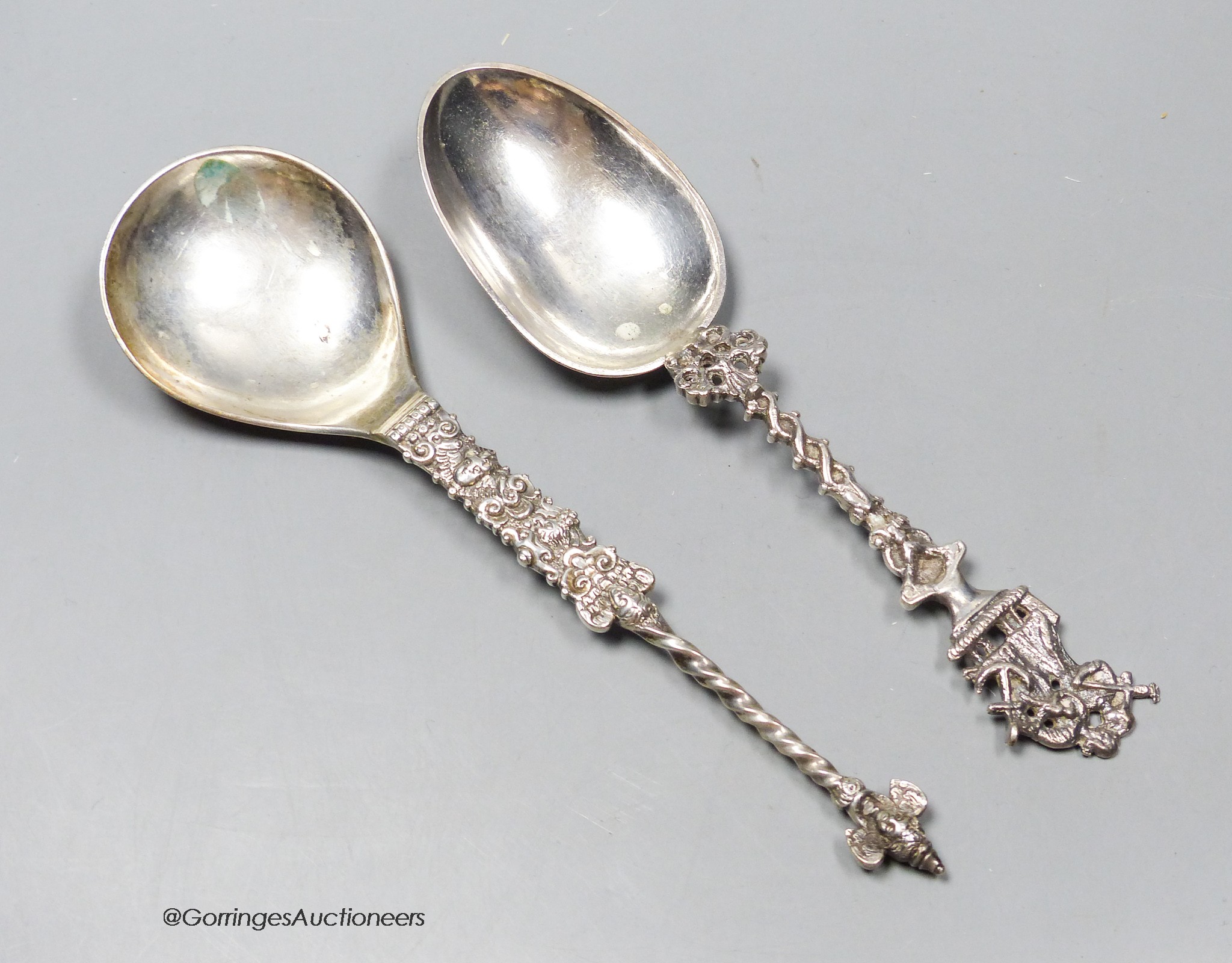 A late 19th century ornate Swedish white metal spoon, with demi-twist handle and mask terminal, 1873, 19.7cm and one other Scandinavian spoon, 123 grams.